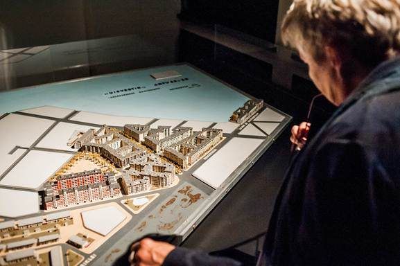 Bezoeker bekijkt een maquette tijdens de tentoonstelling 'Modellenwerk'