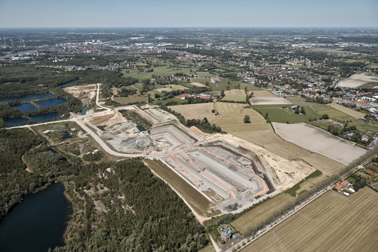 Een luchtfoto toont een lappendeken aan grondgebruik. Centraal zijn enkele actieve kleigroeves zichtbaar. Deze zijn omzoomd door akkers, weiden en beboste zones met volgelopen voormalige kleiputten. Op iets grotere afstand zijn woonwijken zichtbaar.